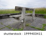 lonely old bench on windswept coast