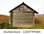 Lonely old dilapidated wooden house in the middle of the field