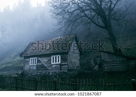 lonely old gloomy house under the black tree in the mountains