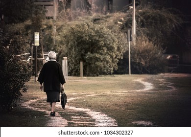 Lonely Old Lady Walking, Pensioner Woman Alone At The Park