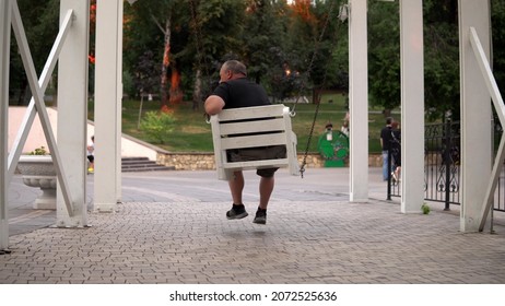 Lonely Old Man Swinging On A Swing In The Park. One Person Resting In The Park