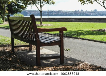 a lonely park bench in sydney harbour park australia