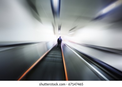 Lonely Person Moving Up On Escalator Stairway. Blurred Motion Perspective.