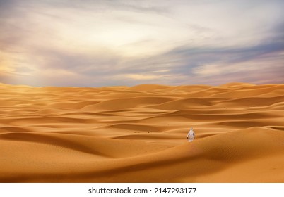 Lonely Person walking in huge desert dunes 