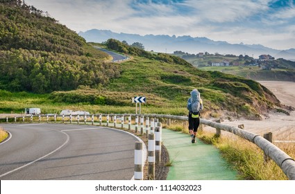 Lonely Pilgrim with backpack walking the Camino de Santiago in Spain, Way of St James