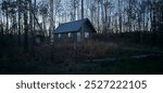 a lonely Ranger cabin, the Sun is setting, darken the area surrounding the would be cabin