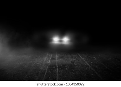 The Lonely Road At Night With The Car Running.