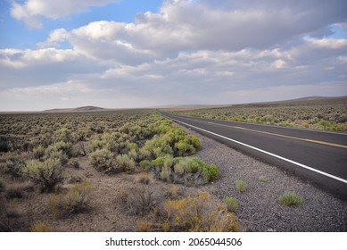 Lonely Road With Sagebrush And Big Sky