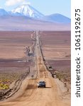 A lonely road with a snoy mountain backdrop in the desert of San Pedro de Atacama in Chile, South America