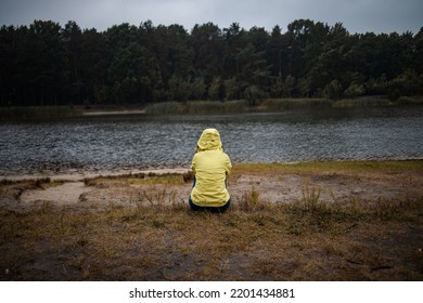 Lonely Sad Woman In Yellow Raincoat In Forest Under Rain, Back View