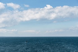 Lonely Sailboat With Red Sails On The Baltic Sea. Small Object On The Sea. Photographed From The Top Deck Of A Ferry. Brave Sailor On The Way To Sweden.