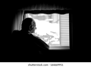 Lonely Senior Man Looking At The Window