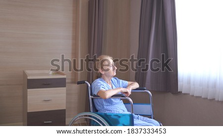 Similar – Senior woman in a wheelchair alone