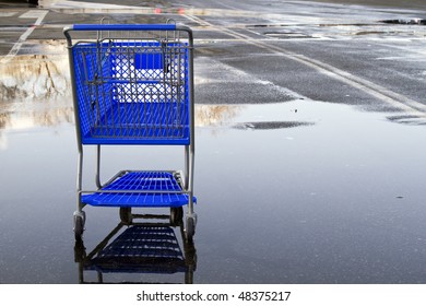 Lonely Shopping Cart On The Empty Parking Lot With Reflection.