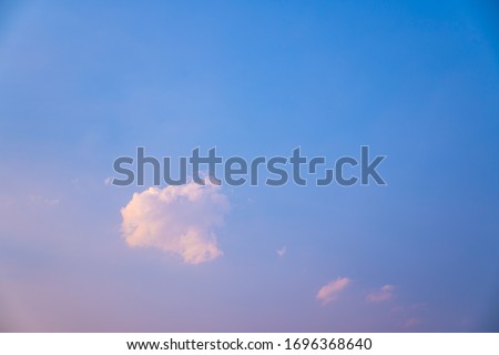 lonely soft clouds floating on blue sky,One white fluffy cloud floating in sky of blue in spring,Anime cloud image,A single puff of a cumulus cloud floats in the air,Cloud images of pink-blue tones.