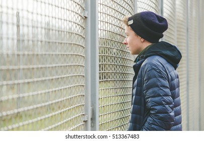 Lonely Teenager In City Sport Place Look Throw Metallic Wall.