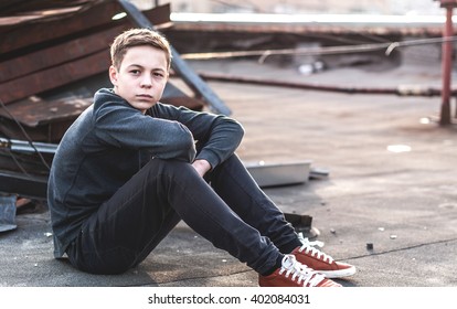 Lonely Teenager Sitting On Roof The House