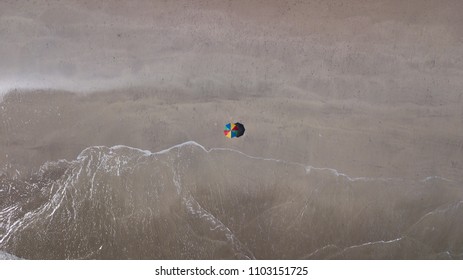 Lonely Umbrella On The Beach