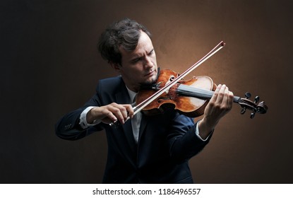 Lonely violinist composing on cello with nothing around