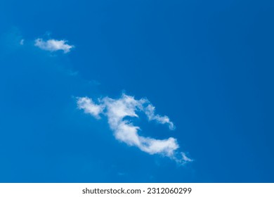 Lonely white little cloud against a blue sky natural background. - Shutterstock ID 2312060299