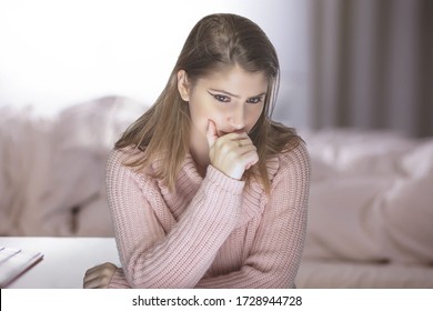 Lonely Woman At Home During A Pandemic Lockdown Or Quarantine Feeling Despair And Sadness Because Of Unemployment And Furlough.  She Is Isolated And Stuck In The Apartment And Is Stressful For Mental 