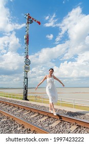 Lonely Woman Try To Balance At The Railway To Feel Happy And Funny. The Words Means That 