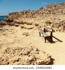 A lonely wooden bench on the seaside. Old bench in Cape Capo Greco. - Powered by Shutterstock