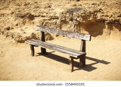 A lonely wooden bench on the seaside. Old bench in Cape Capo Greco. - Powered by Shutterstock