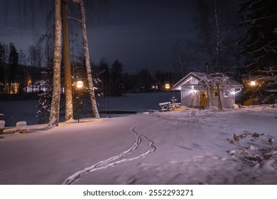 Lonely wooden cabin on the shore of a frozen lake. Snowy landscape at night in Lempäälä, Finland - Powered by Shutterstock