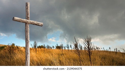 A Lonely Wooden Cross On An Autumn Field