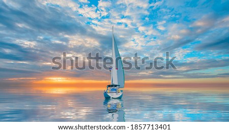 Lonely yacht sailing in the Mediterranean sea at amazing sunset - Sailing luxury yacht with white sails in the Sea.