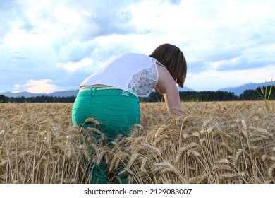 Lonely young female, attractive girl in ripe barley.