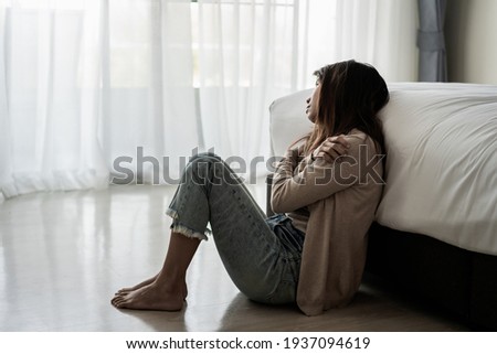 Lonely young woman feeling depressed and stressed sitting in the dark bedroom, Negative emotion and mental health concept