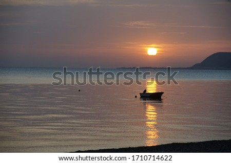 Lonesome Fishingboat at Sunset on the Sea