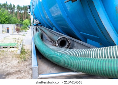 Long 4 Inch PVC Suction Hoses Lie Next To The Tank Of The Septic Tank Truck.