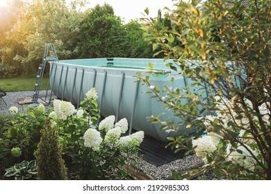 Long, Above Ground, Rectangular, Rack (frame) Swimming Pool Outdoor In The Beautiful Garden Nook. Summer Holiday (vacation) And Recreation.