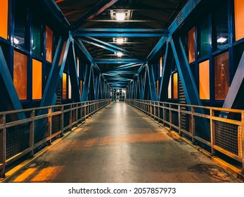 A long aboveground pedestrian crossing. The light from the lanterns passes through the windows - Powered by Shutterstock