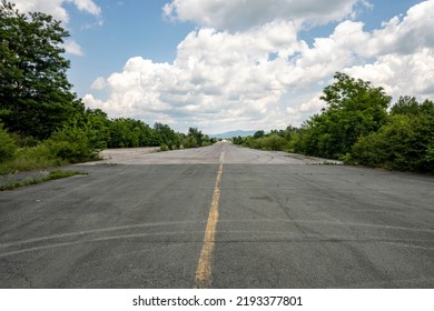 Long, aeroplane runway at the forsaken and abandoned Zeljava military airbase, Croatia, now popular tourist destination for bikers and adventure seekers - Shutterstock ID 2193377801