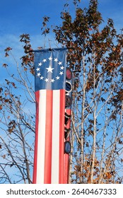 A long Amercan flag style banner with stars and stripes decorates a park near the Fourth of July