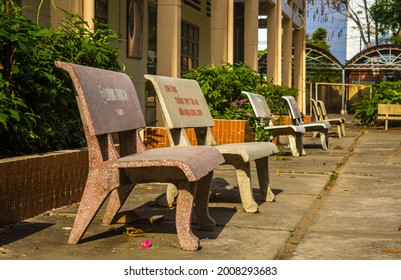 Long An, Vietnam - February 8, 2019: Close up view of empty concrete benches in schoolyard. The name of the contributors were added to the benches
