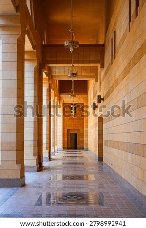 Long arcade corridor with ocre stone pillars in Sheikh Mohammed Bin Ibrahim Mosque in Riyadh, Saudi Arabia