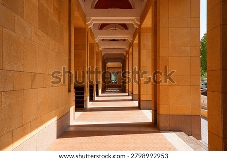 Long arcade corridor with ocre stone pillars in Sheikh Mohammed Bin Ibrahim Mosque in Riyadh, Saudi Arabia
