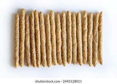 Long artisanal breadsticks with sesame seeds isolated on white background. Bakery products. Copy space. Overhead view. - Powered by Shutterstock