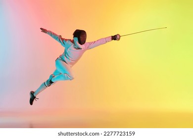 Long attack. Young man, male fencer with sword practicing in fencing over gradient pink-yellow background in neon light. Sportsman shows fencing technique. Copyspace for ad. - Powered by Shutterstock