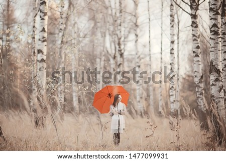 long background girl umbrella / horizontal view rainy autumn day young woman with umbrella