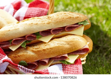 Long baguette sandwiches with salami and cheese for a picnic - Powered by Shutterstock