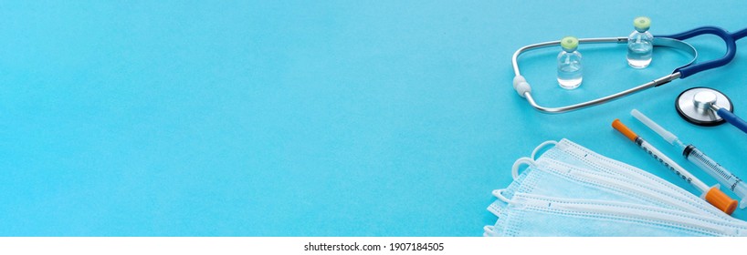 Long banner with medical utensils for an advertising header on the website of medical services, clinics, health insurance. Medical supplies on a blue background. COVID-19 vaccination service concept.