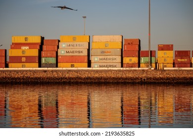 Long Beach, California - August 13, 2022: Reflections From Cargo Containers Are Seen On The Water During Sunrise At The Port Of Long Beach.