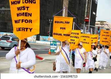 Long Beach, California Nov. 15, 2019; Members of Long Beach Suffrage 100 march towards the Long Beach Convention Center for this weekend's California Democratic Party convention.