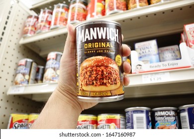 Long Beach, California, United States - 02-12-2020: A Hand Holds A Can Of Manwich Original Sloppy Joe Sauce, On Display At A Local Grocery Store.